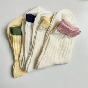 Comfortable women's mid-tube hollow knit socks with colorful cuffs, stylish daily wear.