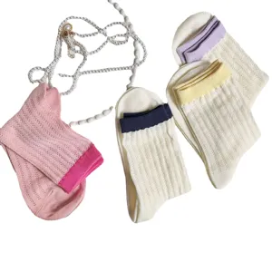 Womens hollow out mid tube socks with colorful ribbed cuffs and pearl decor main view