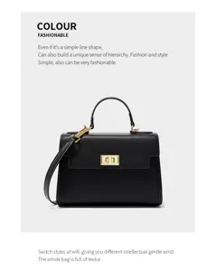 Detailed view of the black leather mini Kelly bag featuring gold hardware and elegant top handle.