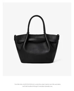 Dettaglio borsa secchiello in pelle nera con pregiata grana e manico elegante.
