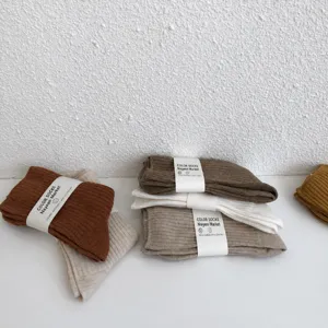 Autumn winter minimalist solid color mid-calf cotton socks detail display with paper band wrap.