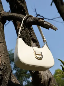 Minimalist white leather baguette shoulder bag for women, chic commuter crossbody purse.