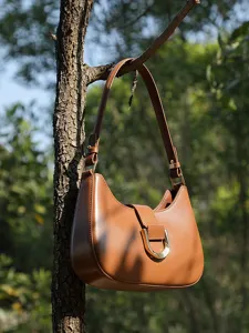 Stylish brown leather shoulder bag for women, minimalist baguette crossbody bag for daily commute.