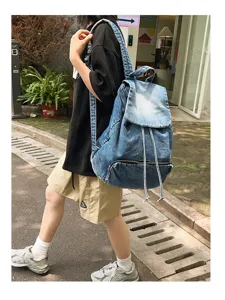Details of the vintage denim backpack showing large capacity and stylish slouchy design.