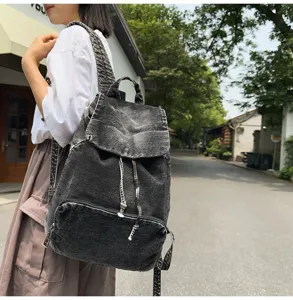 Retro denim backpack outdoor detail view, vintage black canvas casual large capacity bag.