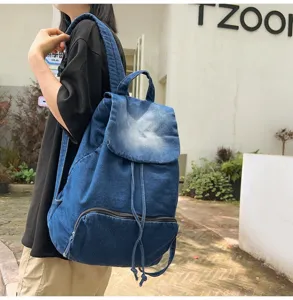Outdoor detail view of casual blue denim backpack, highlighting durable fabric and vintage style.