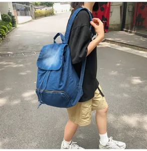 Vintage denim backpack for women, casual stylish canvas rucksack with spacious storage capacity.