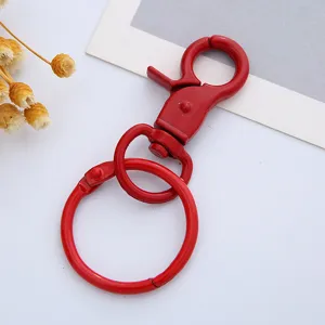 Red metal lobster clasp swivel keychain detail view, ideal hardware for DIY jewelry making accessories.