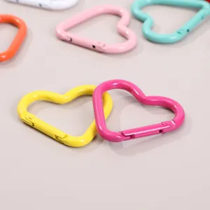 Detailed shot of colorful heart-shaped alloy spring carabiners, keychain diy parts.