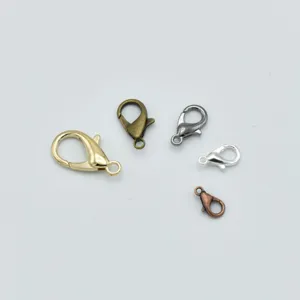 Close-up detail of assorted zinc alloy lobster clasps in various metallic finishes and sizes.