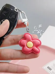 Detailed view of the cute pink puffy flower keychain charm, sweet candy color accessory for bags.