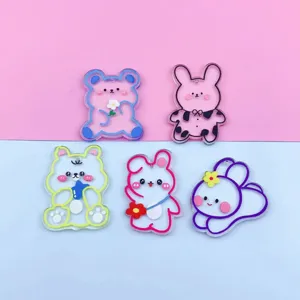 Cute cartoon bear and rabbit acrylic pendant details showing vivid colors and smooth edges.