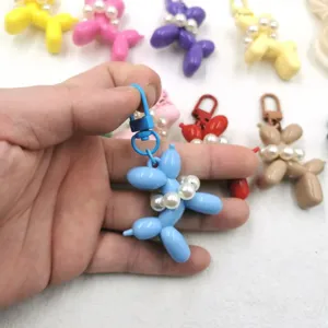 Acrylic balloon dog keychain pendant detail view, cute pearl collar keyring charm accessory.