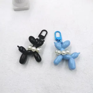 Acrylic balloon dog keychain with pearl necklace pendant, cute animal bag charm for women.
