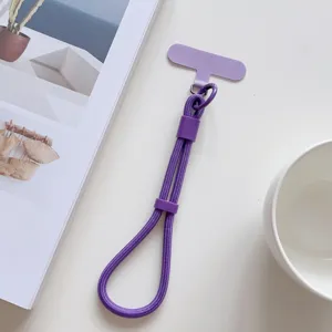 Correa de muñeca morada para teléfono móvil con lengüeta de fijación, cordón ajustable.