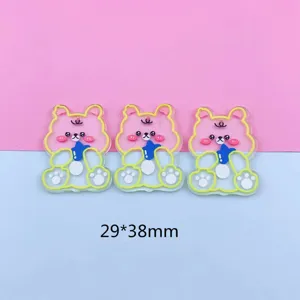 Acrylic cartoon bear pendant detail showing double-sided transparent design and clear outline.