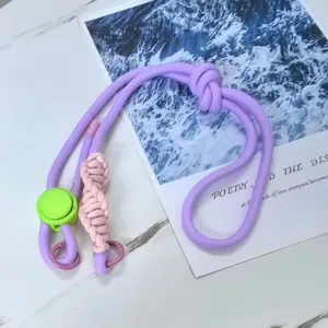 Close-up detail of the purple and pink cross-body phone lanyard with adjustable plastic buckle.