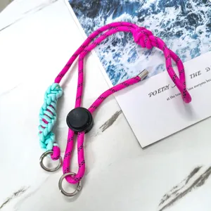 Pink and light blue braided universal phone lanyard detail with adjustable buckle rings.