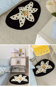Black oval tufted floral rug with white dotted flower design, cozy bedroom bedside decorative mat.