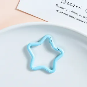 Blue star-shaped spring snap hook metal keychain accessory DIY jewelry pendant clasp detail shot.