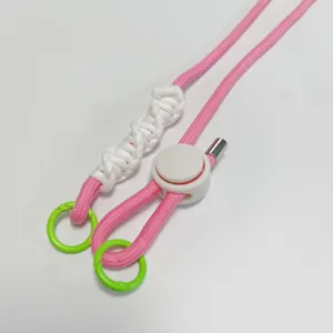Detailed view of pink white colorblock phone lanyard with adjustable buckle and rings.