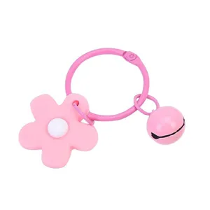 Candy pink metal ring keychain featuring a cute PVC flower charm and a matching jingle bell.