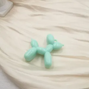 Mint green balloon dog acrylic pendant detail showing the glossy finish and cute animal shape.