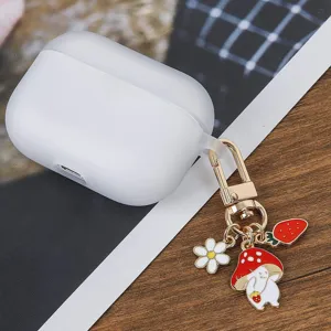 Silicone AirPods case detail shot featuring a cute mushroom and flower metal keychain charm.