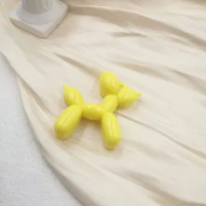 Yellow balloon dog charm detail shot, acrylic keychain pendant for phone case DIY accessories.