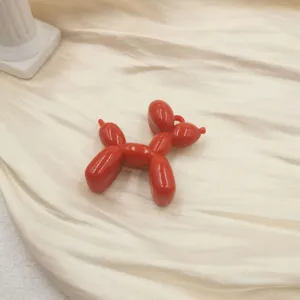 Red acrylic balloon dog charm detail shot, perfect for DIY keychains and cute phone cases.