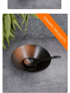 Detailed view of Japanese style ceramic soup bowl and spoon on grey texture table surface.
