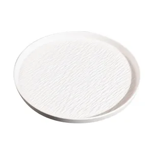 White ceramic round dinner plate with textured ripple design for kitchen and dining table use.