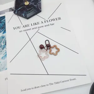 Detailed close-up view of the cute acrylic star keychain charms and paper.