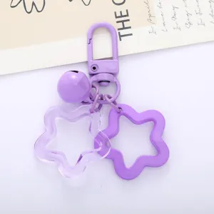 Purple acrylic star keychain bag pendant with bell and clasp, cute aesthetic accessory.