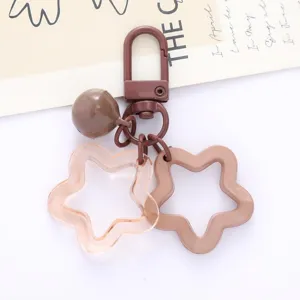 Cute acrylic star keychain charm with bell pendant, perfect for bags and DIY accessories.