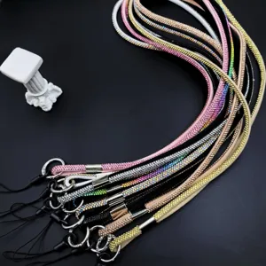 Detailed view of sparkly rhinestone phone lanyard straps with metal rings in various colors.
