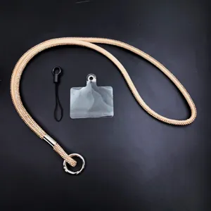Rhinestone phone lanyard detail featuring sparkling crystals, metal ring and clear patch.