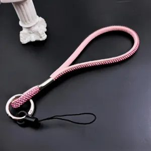 Rhinestone phone lanyard detail, sparkling pink crystal wrist strap showcasing fine craftsmanship.