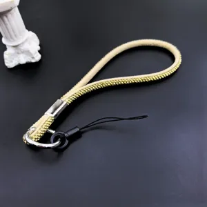 Sparkling rhinestone phone strap detail, elegant diamond wrist lanyard and chain accessory.