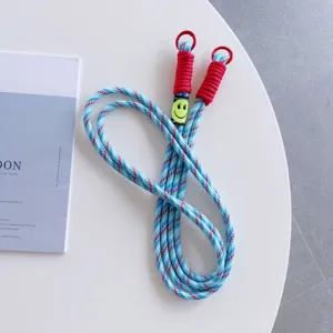Blue red woven phone lanyard cross body strap with red rings and smiley face cute charm.