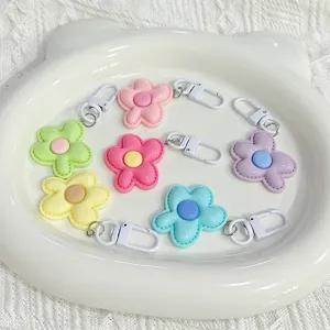 Cute candy color flower keychain pendant, pastel dopamine style bag charm detail view.