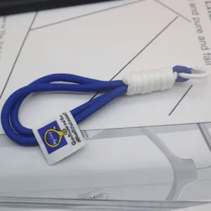 Nylon woven rope keychain detail, blue and white braided strap with metal carabiner for bags.