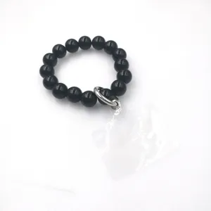 Bracelet de téléphone en perles noires avec languette transparente, dragonne élégante.