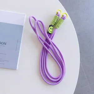 Purple phone lanyard with smiley face, dual buckle crossbody hanging rope detail view.