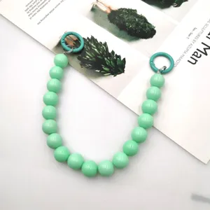 Detailed shot of 14mm light green acrylic round bead handle chain for DIY phone case accessories.