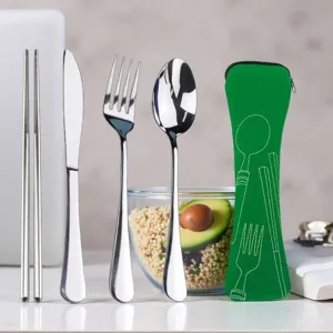 Reusable stainless steel travel cutlery set with portable green storage bag for camping.