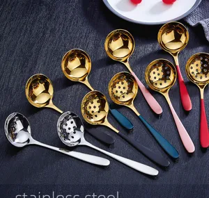 Stainless steel soup spoon and slotted spoon detail view, colorful handles kitchen tableware