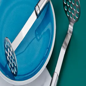 Stainless steel potato masher kitchen tool detail view for baby food and vegetable mashing.