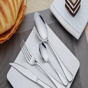 Stainless steel cutlery set featuring knife fork and spoon in a elegant white plate detail view.