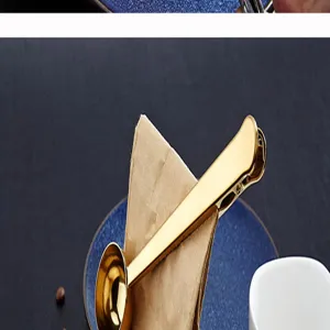 Close-up detail of golden stainless steel coffee measuring spoon with bag sealing clip.